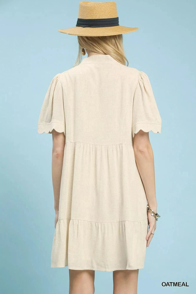 Umgee Linen Tiered Babydoll Dress with Scalloped Sleeves back of dress blue background