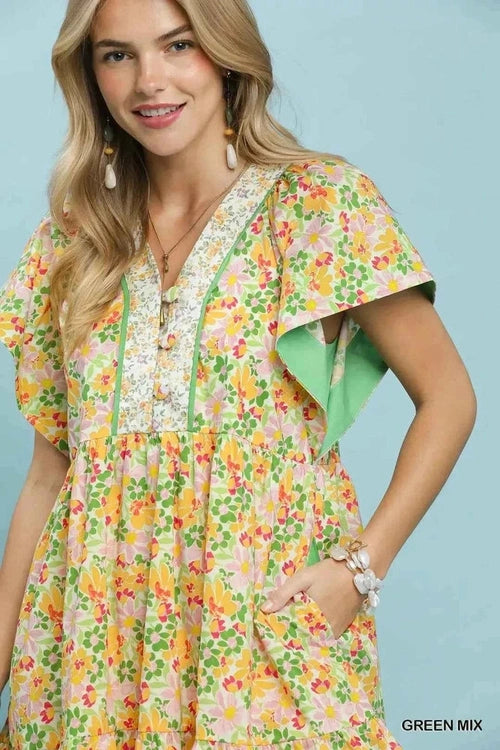 Woman wearing a floral dress with a green background