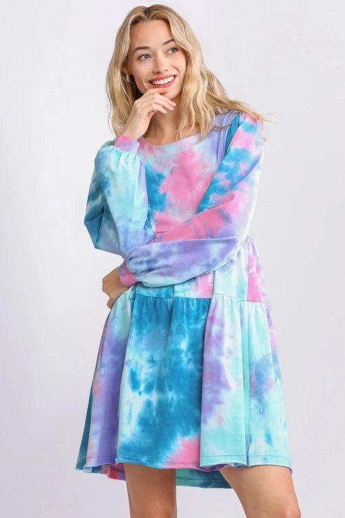 Woman wearing a colorful tie-dye dress on a white background