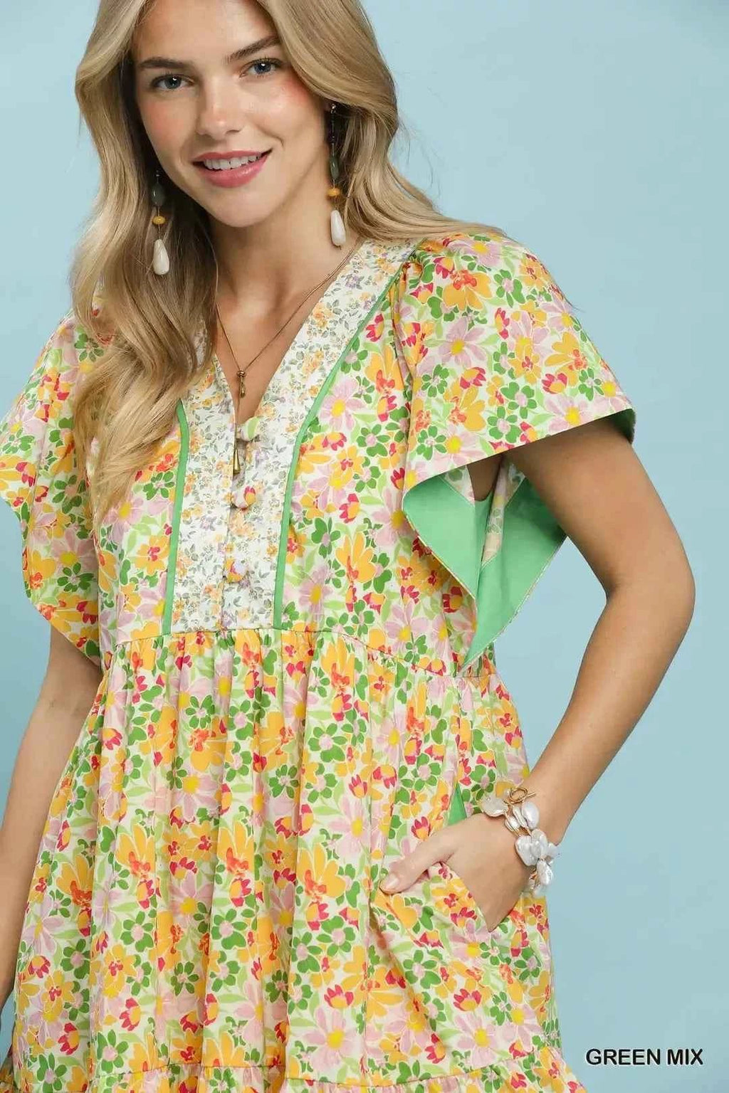 Woman wearing a floral dress with a green background