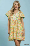 Woman wearing a floral dress with a green background
