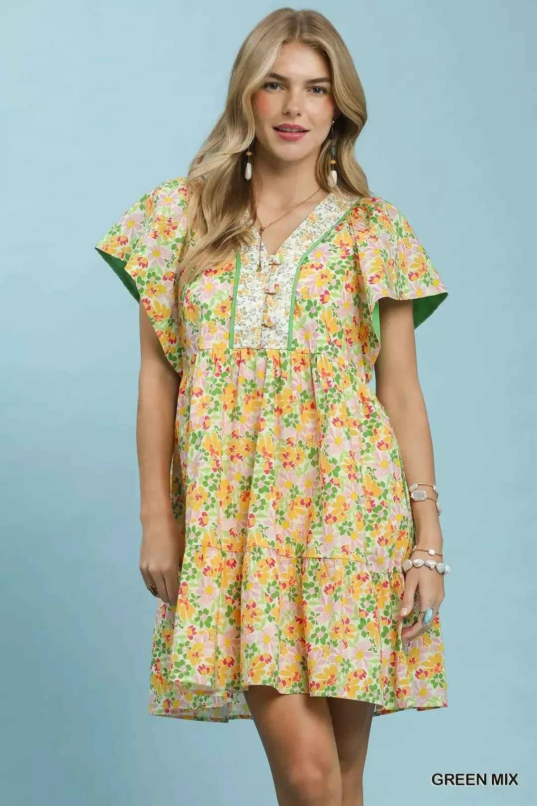 Woman wearing a floral dress with a green background