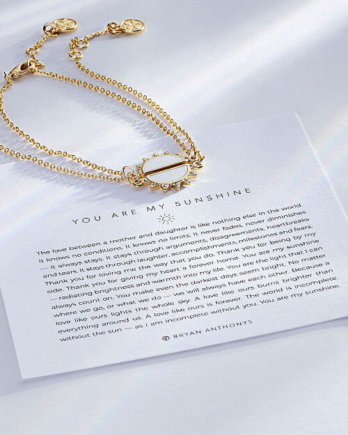 Gold bracelet on a card with 'You are my sunshine' message