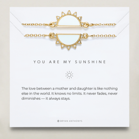 Gold bracelet with sun design on a card with 'You are my sunshine' message