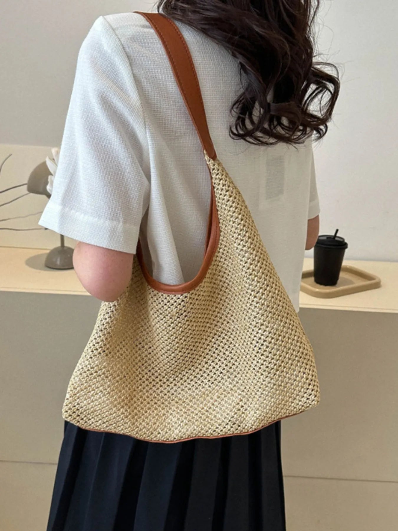 Woven Straw Shoulder Bag - on left shoulder white wall