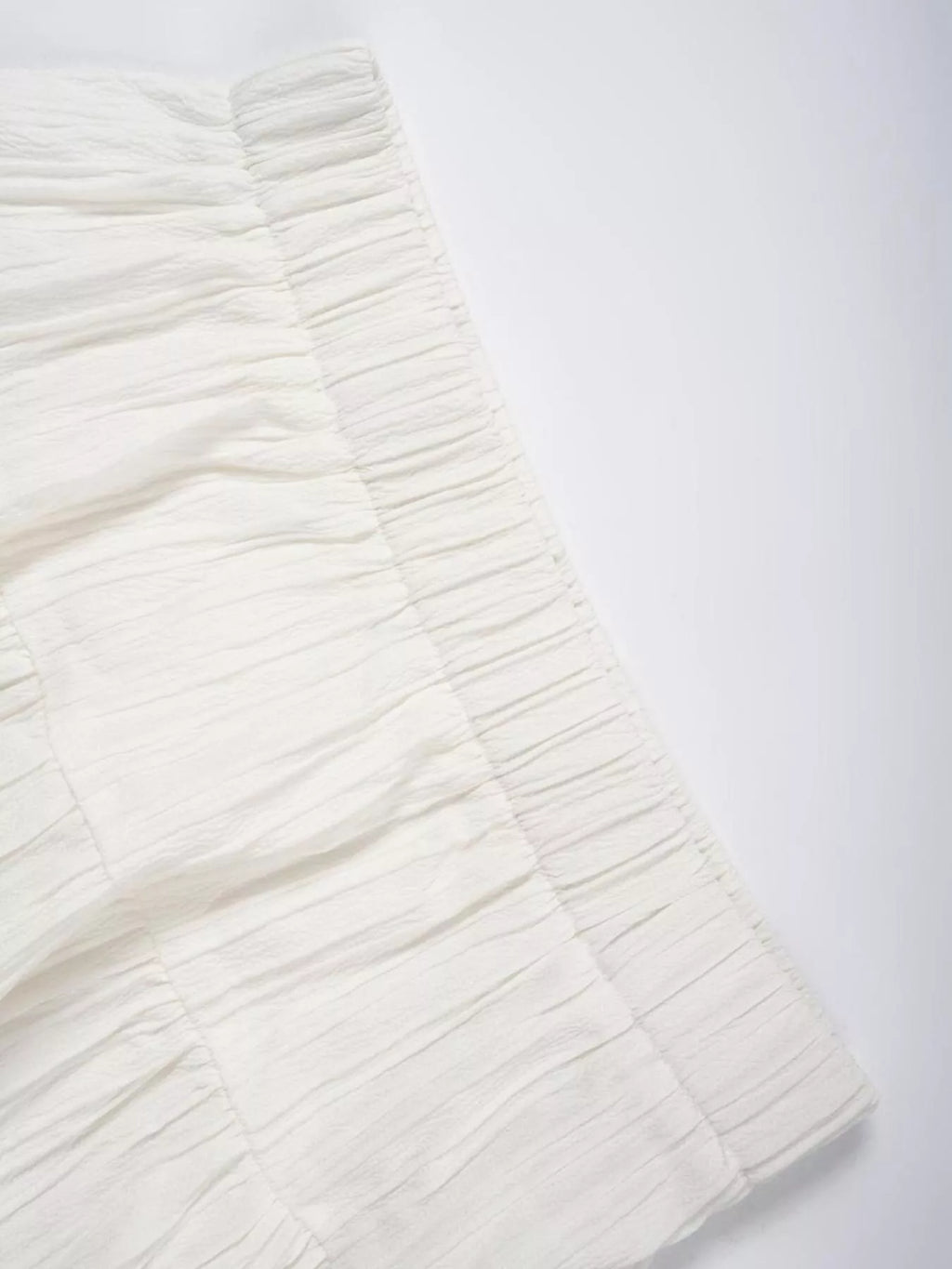 White Ruched tiered fabric on white table
