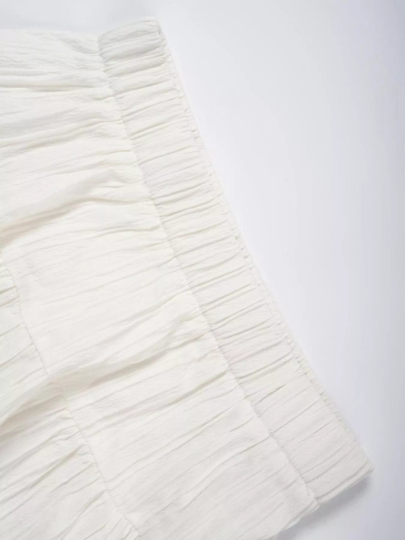 White Ruched tiered fabric on white table