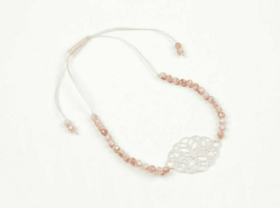 Necklace with pink beads and a silver clasp on a white background