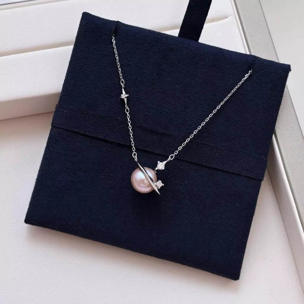 Necklace with a pink pearl pendant on a black jewelry box