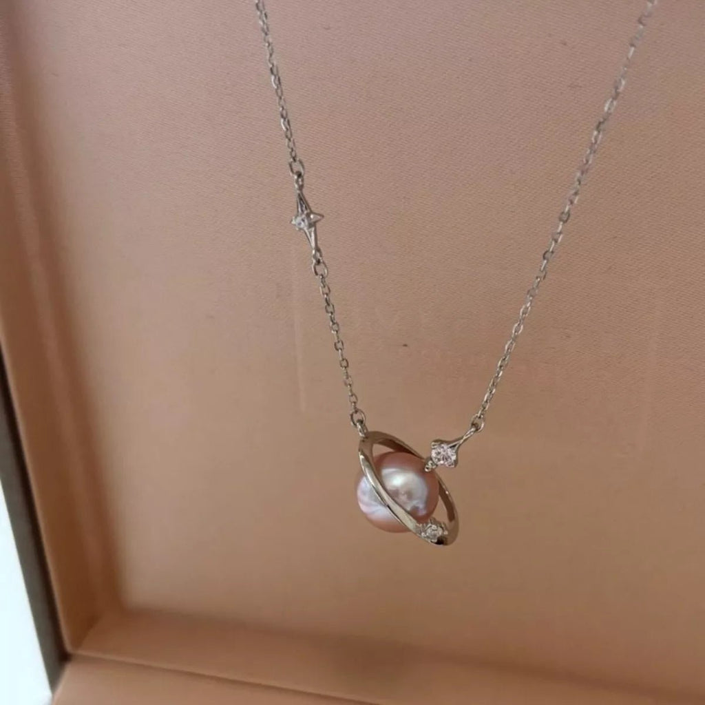 Necklace with a pearl pendant on a beige background