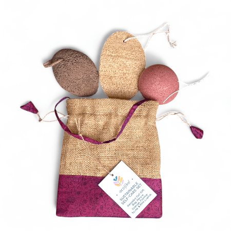 Set of natural exfoliating tools in a drawstring bag with a visible brand tag on a white background.