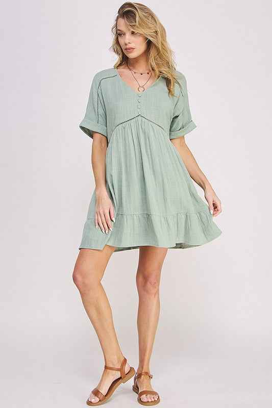 Woman wearing a light green dress on a white background