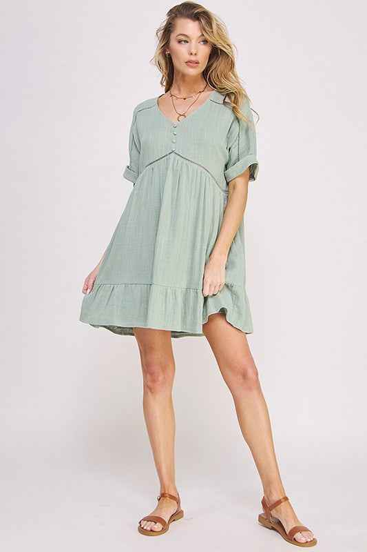 Woman wearing a light green dress on a white background