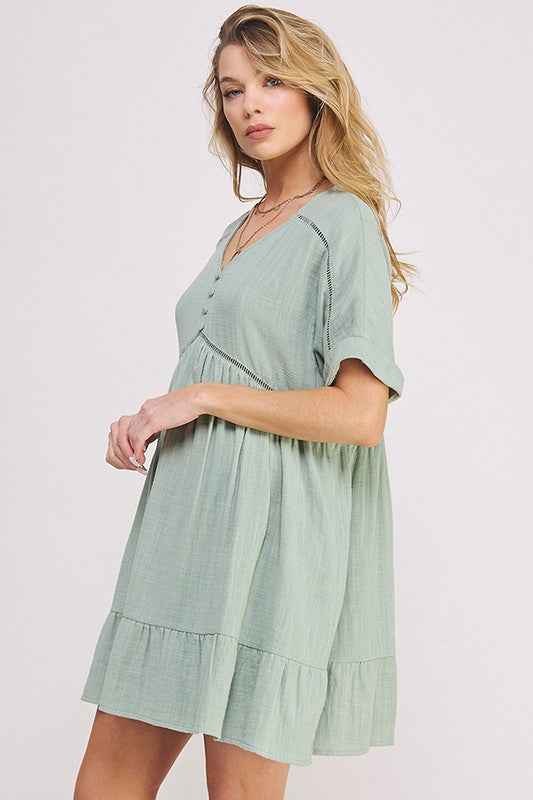 Blonde woman wearing a light green dress on a white background