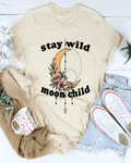 Beige t-shirt with 'stay wild moon child' design, mug, sweater, and jeans on a white background