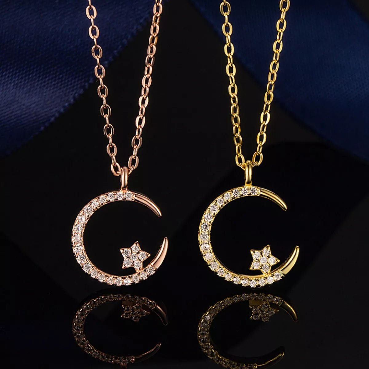 Two gold necklaces with moon and star pendants on a dark background
