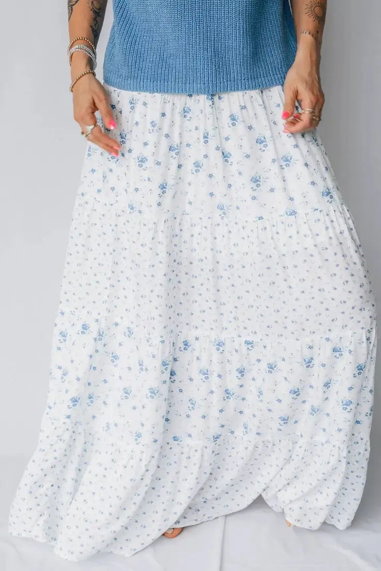 White floral skirt with blue flowers on a plain background